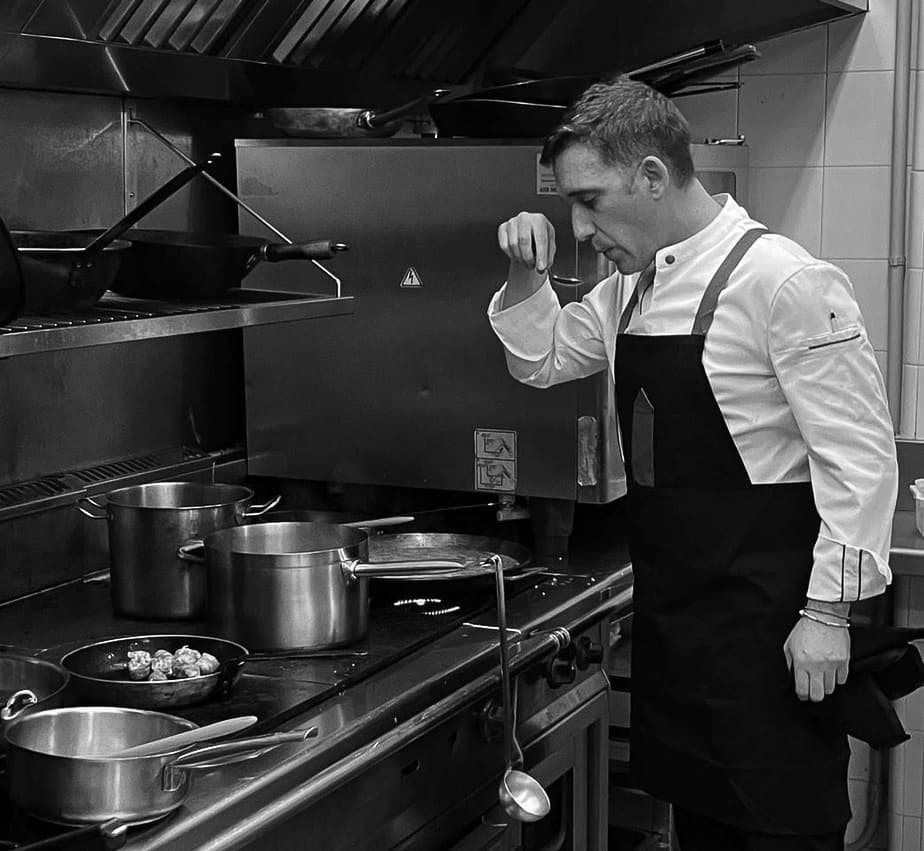 A BioChef at the stove in a professional kitchen