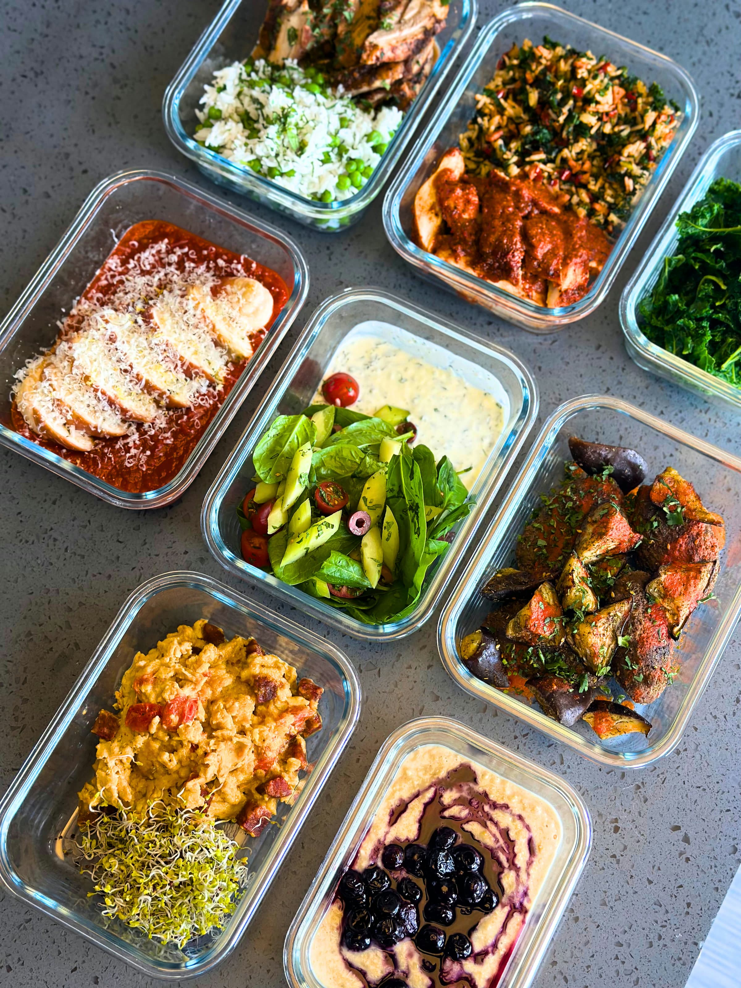 A week of chef-prepared meals portioned into glass containers